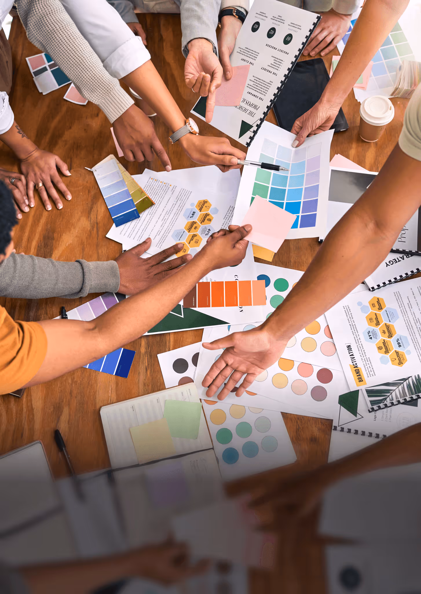 photo of lots of hands doing design work