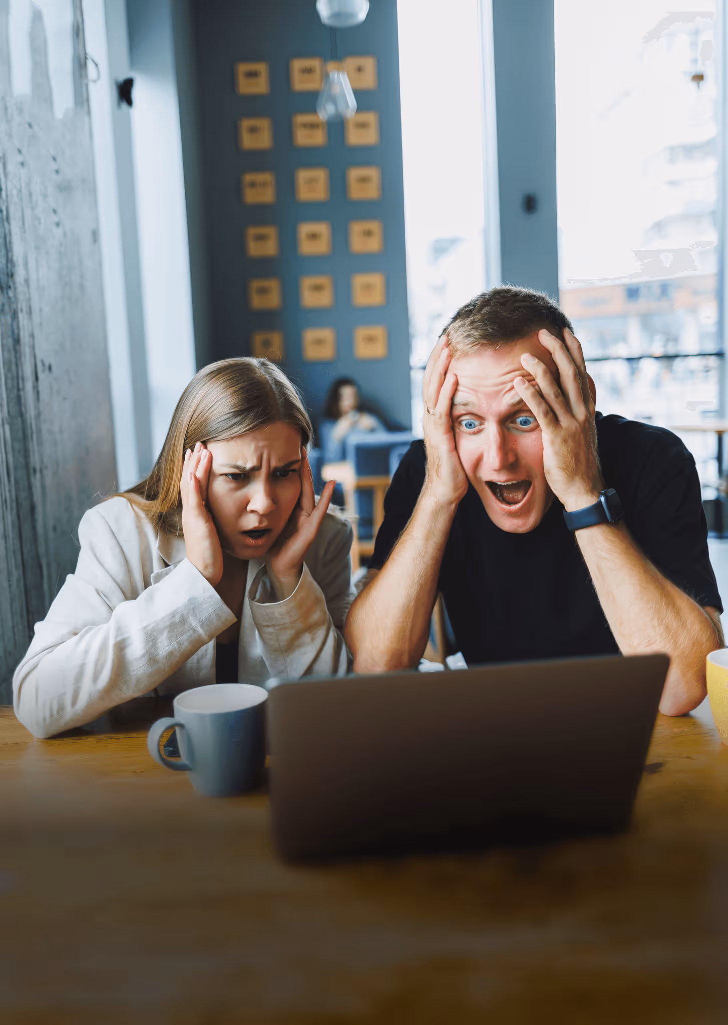 photo of two stressed people looking at a laptop